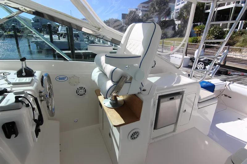Bloody Knuckles Yacht Photos Pics 2008 Bertram 360 yacht cockpit with helm seat and control panel, docked at marina.