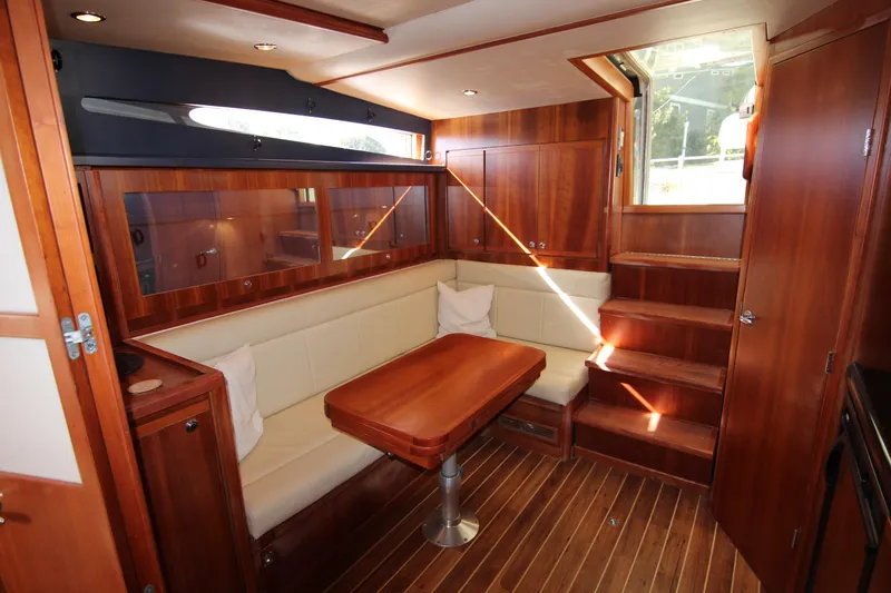 Bloody Knuckles Yacht Photos Pics Luxurious interior of 2008 Bertram 360 yacht with wooden finishes and cozy seating area.