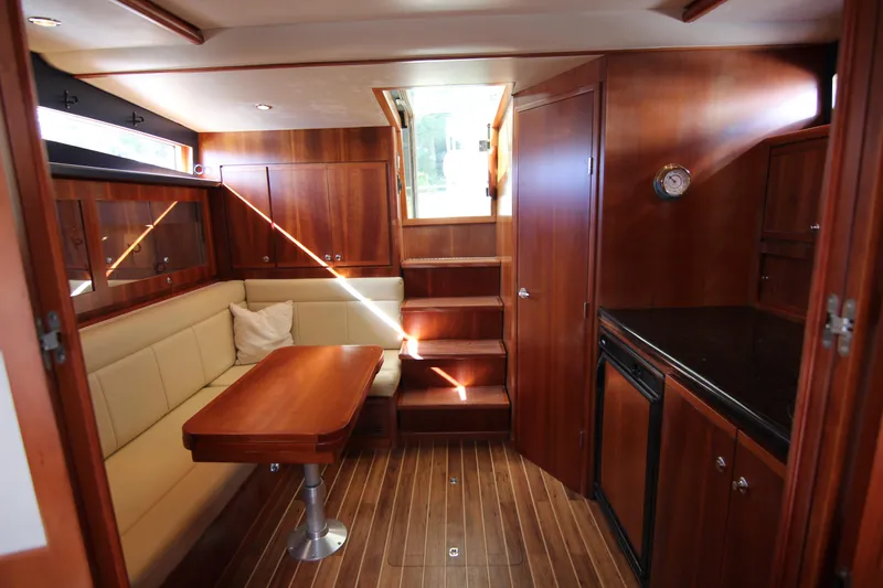 Bloody Knuckles Yacht Photos Pics Luxurious 2008 Bertram 360 yacht interior with wood finish and cozy seating area.