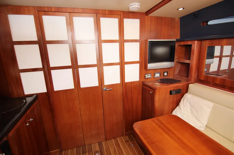 Bloody Knuckles Yacht Photos Pics Interior of 2008 Bertram 360 yacht with wood paneling, TV, and seating area.