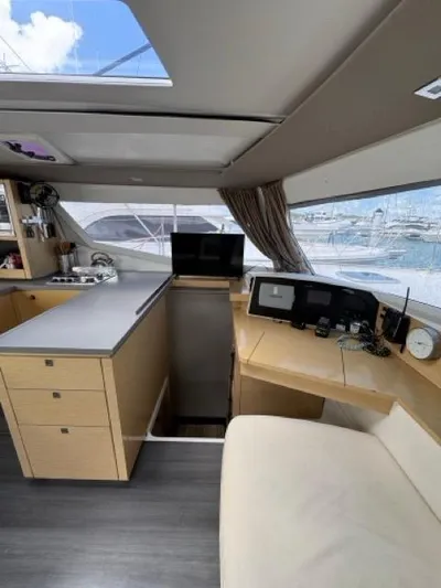 Island State Of Mind Yacht Photos Pics Interior of 2014 Fountaine Pajot Helia 44 catamaran with modern kitchen and navigation area.