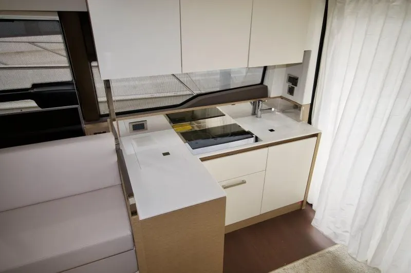 Skylark Yacht Photos Pics Modern kitchen interior of 2018 Prestige 460 S yacht, featuring sleek cabinetry and appliances.