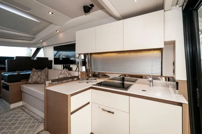 Skylark Yacht Photos Pics Luxurious interior of 2018 Prestige 460 S yacht with modern kitchen and seating area.