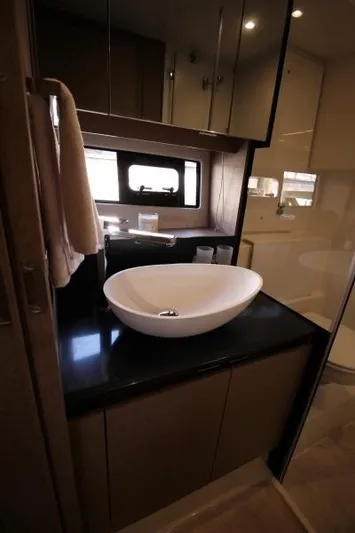 Skylark Yacht Photos Pics Luxurious bathroom interior of 2018 Prestige 460 S yacht with modern sink and window.