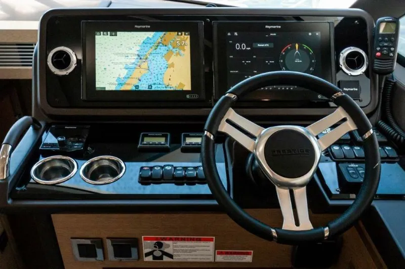 Skylark Yacht Photos Pics 2018 Prestige 460 S yacht dashboard with navigation screens and steering wheel.