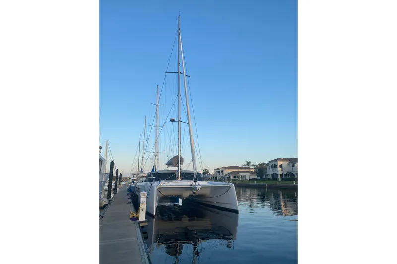 Dauntless Yacht Photos Pics 2024 Seawind 1370 catamaran docked at marina, clear sky background.