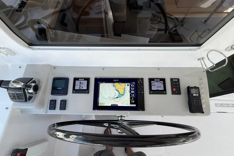 Dauntless Yacht Photos Pics 2024 Seawind 1370 yacht cockpit with navigation controls and display screens.