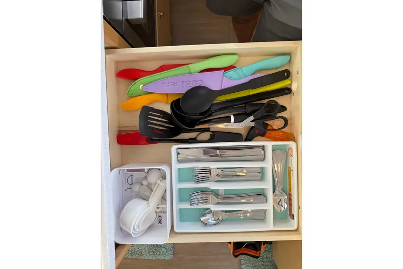 Dauntless Yacht Photos Pics Kitchen drawer with colorful knives, utensils, and cutlery in a Seawind 1370, 2024 model.