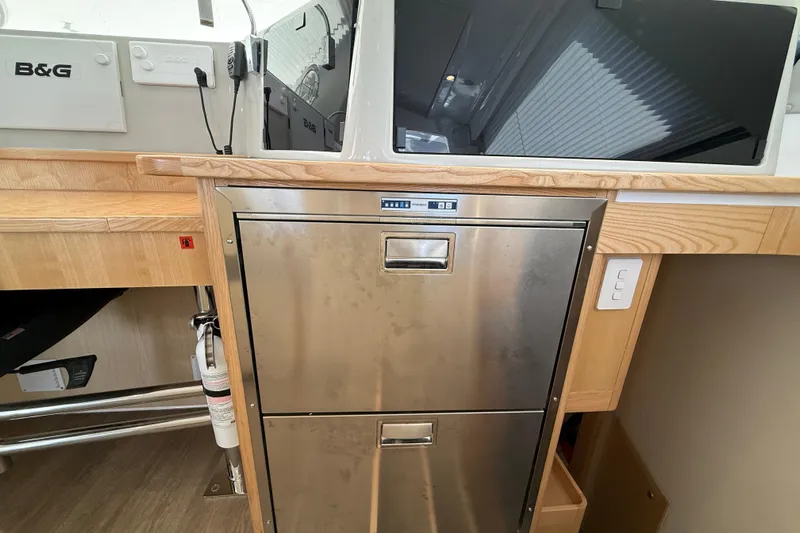 Dauntless Yacht Photos Pics 2024 Seawind 1370 yacht interior with stainless steel appliances and wooden cabinetry.