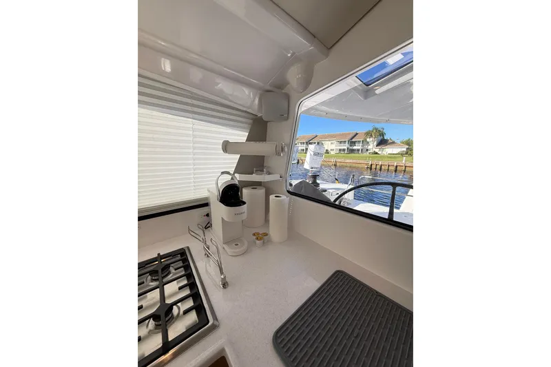 Dauntless Yacht Photos Pics Modern kitchen interior of 2024 Seawind 1370 yacht with stove and coffee maker.