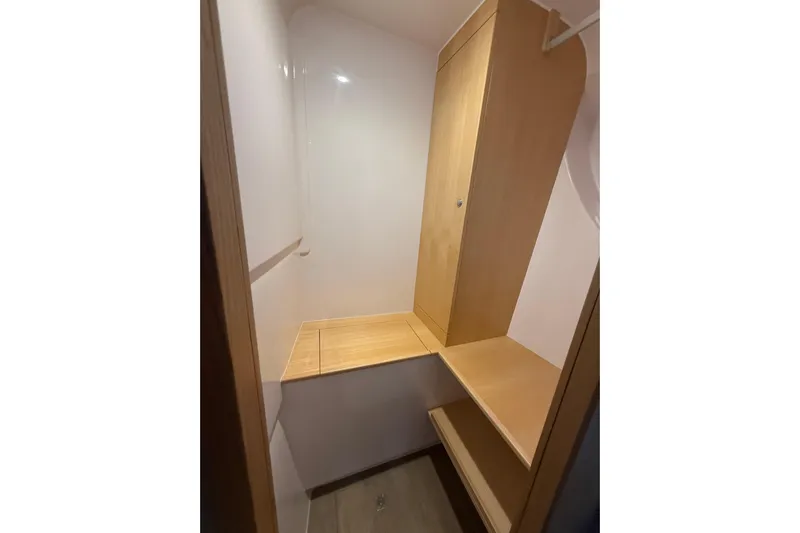 Dauntless Yacht Photos Pics 2024 Seawind 1370 interior closet with wooden shelves and storage space.