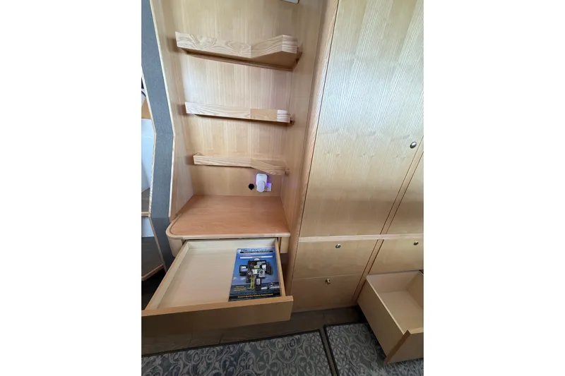 Dauntless Yacht Photos Pics 2024 Seawind 1370 interior with wooden shelves and open drawers.
