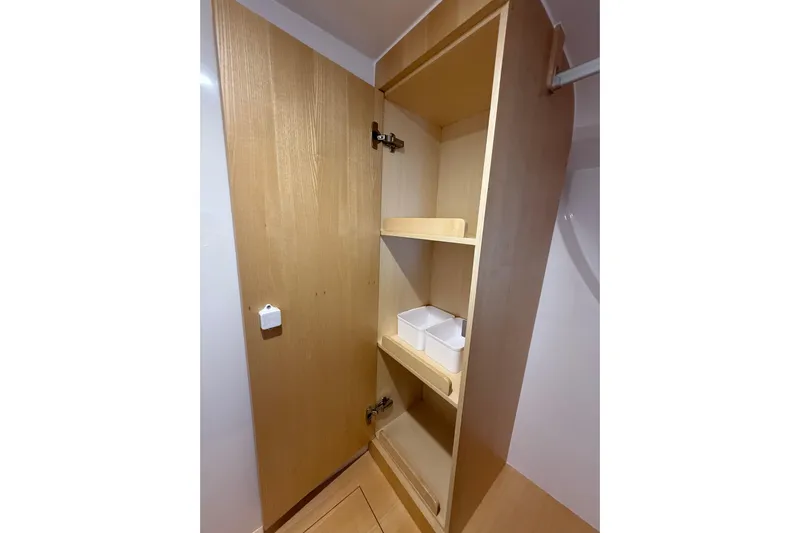 Dauntless Yacht Photos Pics Wooden storage cabinet with shelves inside a 2024 Seawind 1370 yacht.