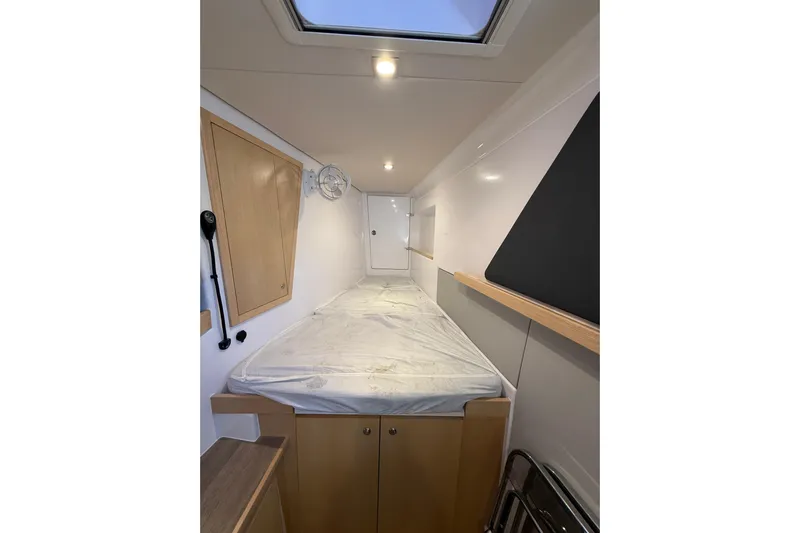 Dauntless Yacht Photos Pics 2024 Seawind 1370 cabin interior with bed, skylight, and wooden accents.