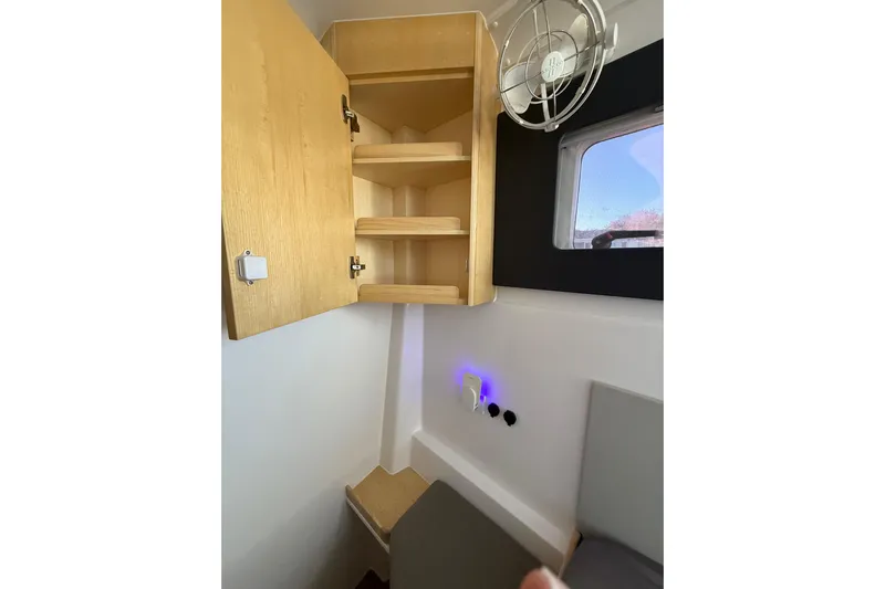 Dauntless Yacht Photos Pics Interior of 2024 Seawind 1370 yacht with wooden cabinet and window.