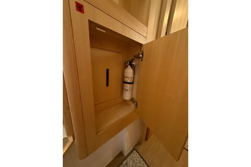 Dauntless Yacht Photos Pics Fire extinguisher in wooden cabinet on 2024 Seawind 1370 yacht.