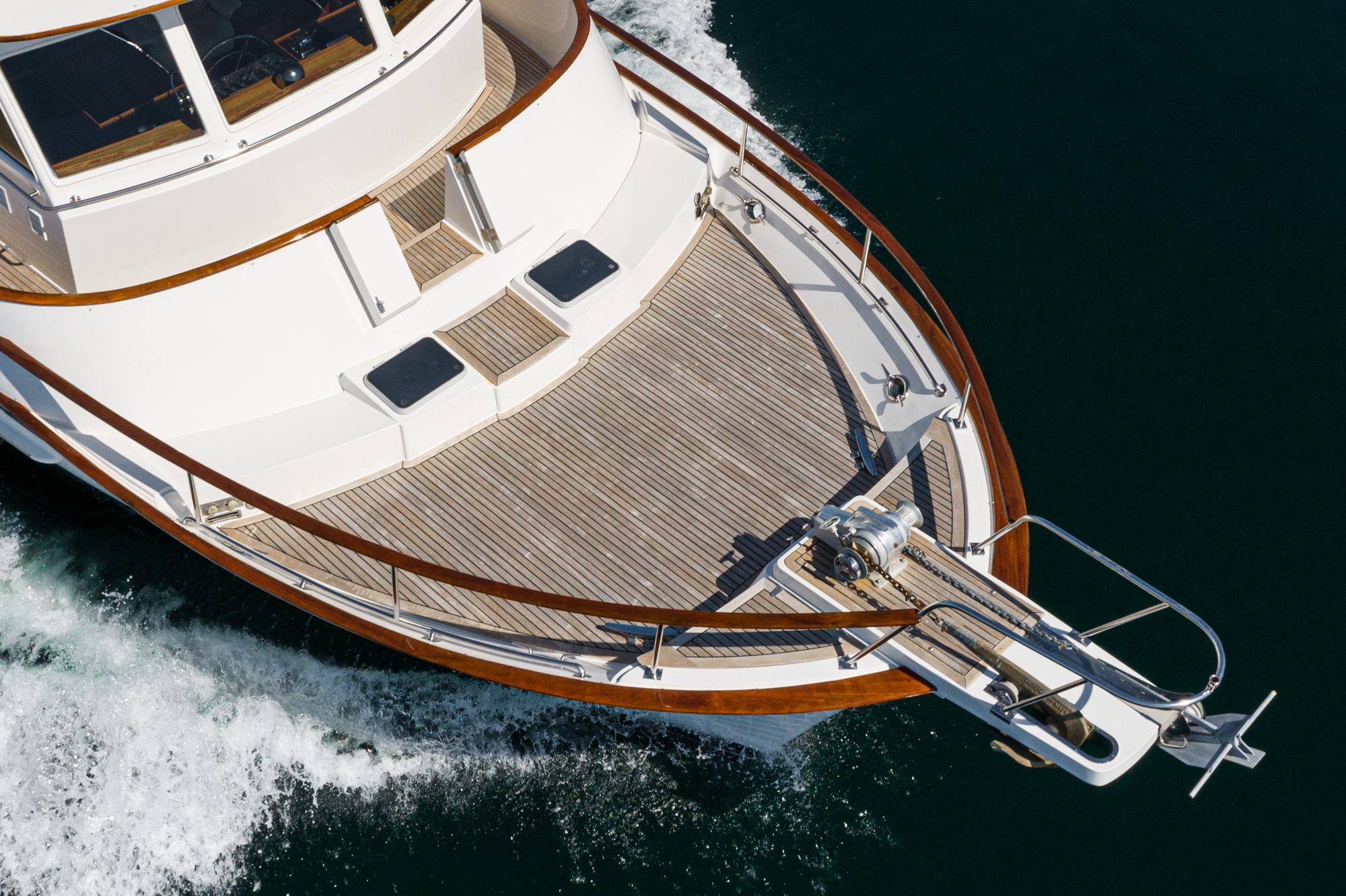 1987 Fleming 50 Raised Pilothouse yacht cruising on water, showcasing elegant deck design.