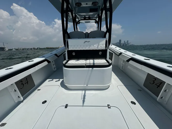  Yacht Photos Pics 2024 Yellowfin 34 Offshore boat on water, showcasing spacious deck and seating.