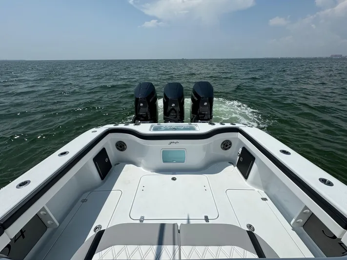  Yacht Photos Pics 2024 Yellowfin 34 Offshore boat with triple engines on open water.