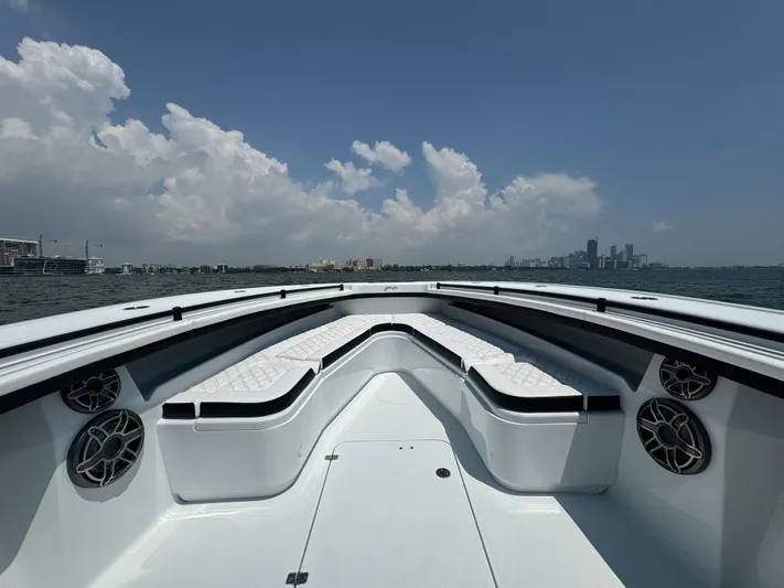  Yacht Photos Pics 2024 Yellowfin 34 Offshore boat with spacious seating, cruising on open water under a clear sky.