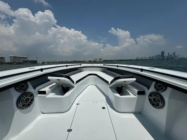  Yacht Photos Pics 2024 Yellowfin 34 Offshore boat interior with seating, speakers, and ocean view.