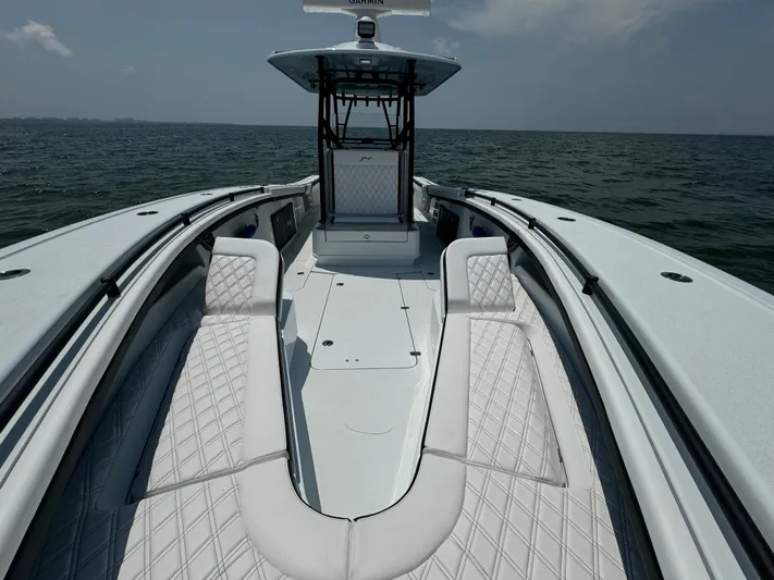  Yacht Photos Pics 2024 Yellowfin 34 Offshore boat interior with cushioned seating, on open water.