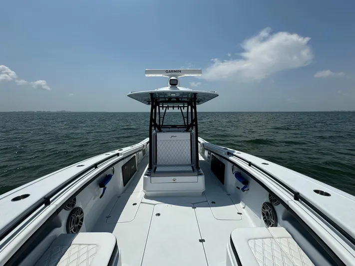  Yacht Photos Pics 2024 Yellowfin 34 Offshore boat on open water, clear sky, Garmin equipment visible.