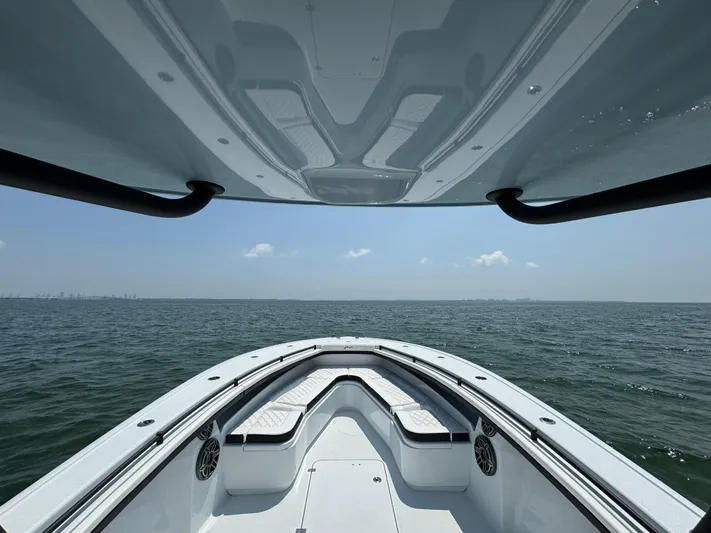  Yacht Photos Pics 2024 Yellowfin 34 Offshore boat on open water, showcasing sleek design and spacious deck.