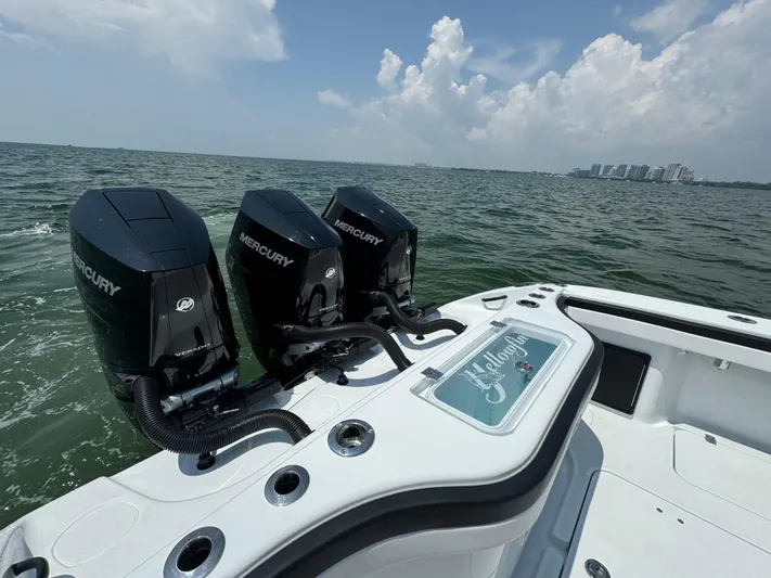  Yacht Photos Pics 2024 Yellowfin 34 Offshore boat with triple Mercury engines on open water.
