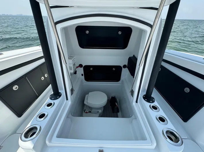  Yacht Photos Pics 2024 Yellowfin 34 Offshore boat interior with toilet, ocean view in background.