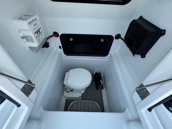  Yacht Photos Pics 2024 Yellowfin 34 Offshore boat interior with compact marine toilet.