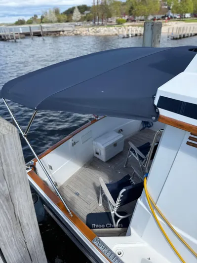  Yacht Photos Pics 1999 Sabreline 34 Flybridge docked, featuring a shaded deck with seating and storage.