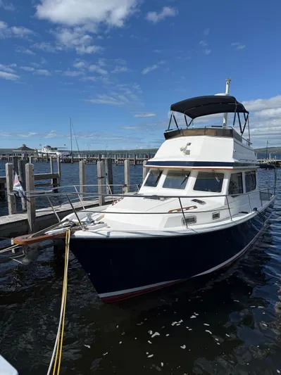  Yacht Photos Pics 1999 Sabreline 34 Flybridge boat docked under a clear blue sky.