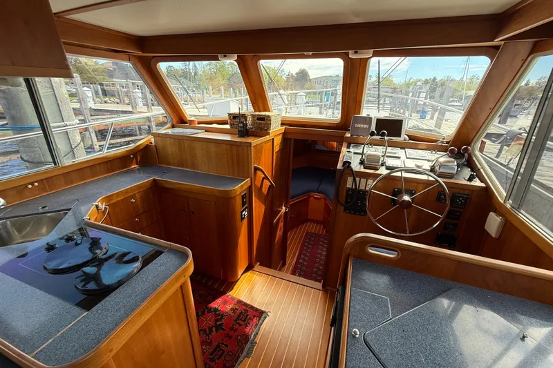  Yacht Photos Pics Interior of 1999 Sabreline 34 Flybridge with wooden finish and helm station.