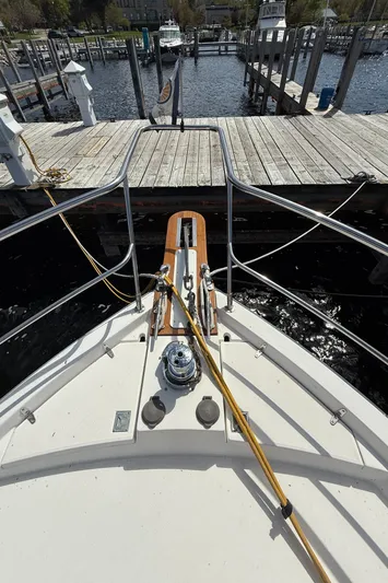  Yacht Photos Pics Bow view of 1999 Sabreline 34 Flybridge docked at a marina.