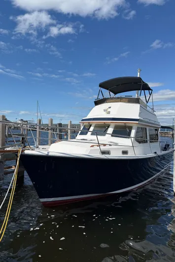  Yacht Photos Pics 1999 Sabreline 34 Flybridge boat docked under a clear blue sky.