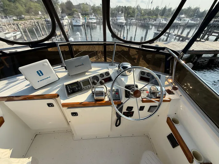  Yacht Photos Pics Flybridge helm of 1999 Sabreline 34 with navigation equipment, overlooking marina.