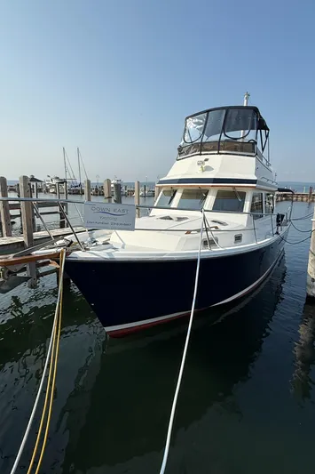 Yacht Photos Pics 1999 Sabreline 34 Flybridge boat docked at marina, clear sky, calm water.