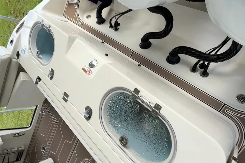  Yacht Photos Pics 2018 Cobia 344 Center Console boat interior with livewell and storage compartments.