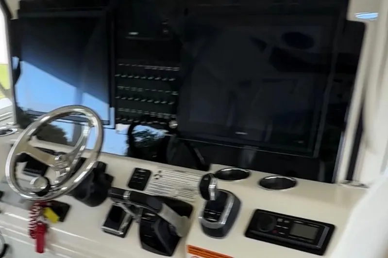  Yacht Photos Pics 2018 Cobia 344 Center Console dashboard with steering wheel and electronic controls.