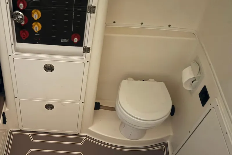  Yacht Photos Pics 2018 Cobia 344 Center Console boat bathroom with toilet and control panel.