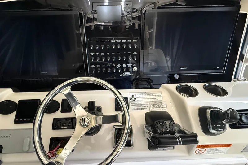 Yacht Photos Pics 2018 Cobia 344 Center Console helm with dual Garmin displays and control panel.