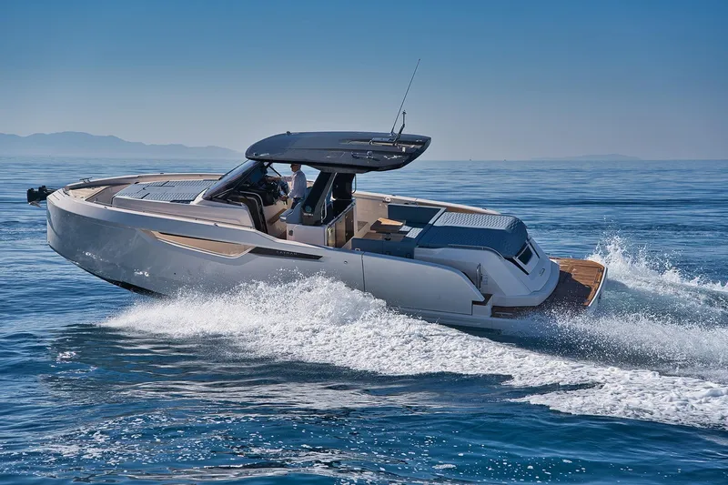  Yacht Photos Pics 2025 Cayman Yachts 380 WA cruising on open water, showcasing sleek design and luxury features.
