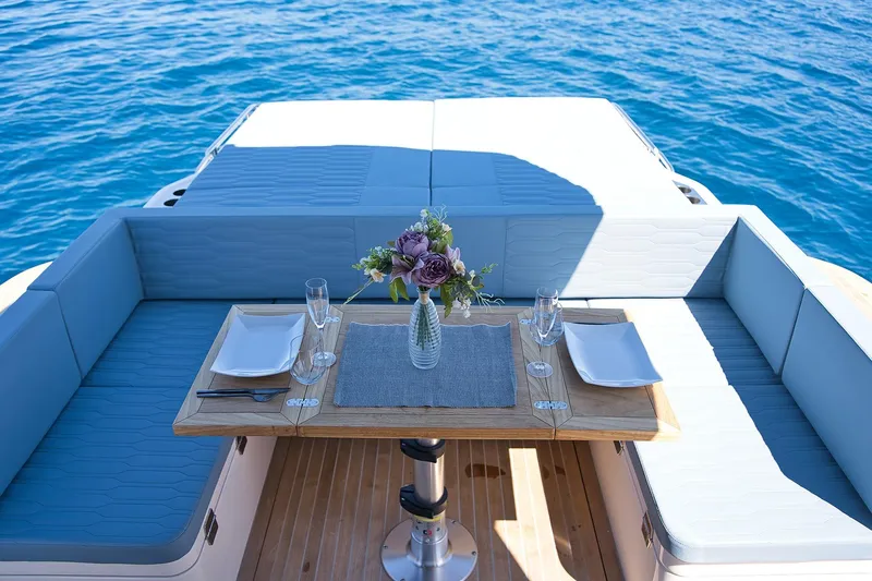  Yacht Photos Pics Luxury dining setup on Cayman Yachts 380 WA, 2025 model, with ocean view.