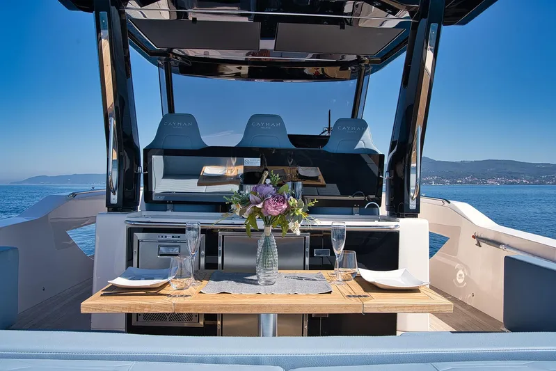  Yacht Photos Pics Luxurious Cayman Yachts 380 WA 2025 model with elegant dining setup on deck.