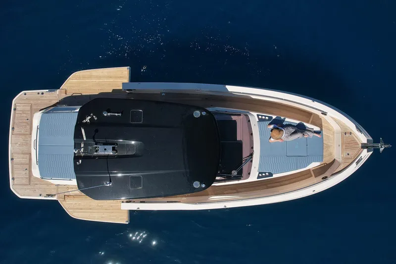  Yacht Photos Pics Aerial view of 2025 Cayman Yachts 380 WA on calm blue water.