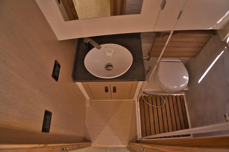  Yacht Photos Pics Modern bathroom interior of 2025 Cayman Yachts 380 WA, featuring sleek sink and toilet design.