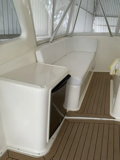 Bona Vida Yacht Photos Pics 1997 Ocean Yachts 48 Convertible interior with seating and wood flooring.
