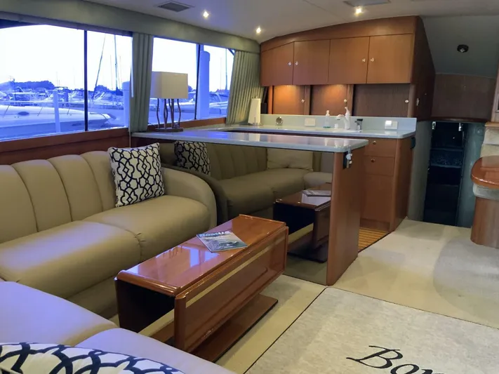 Bona Vida Yacht Photos Pics Luxurious interior of 1997 Ocean Yachts 48 Convertible with elegant seating and modern kitchen.