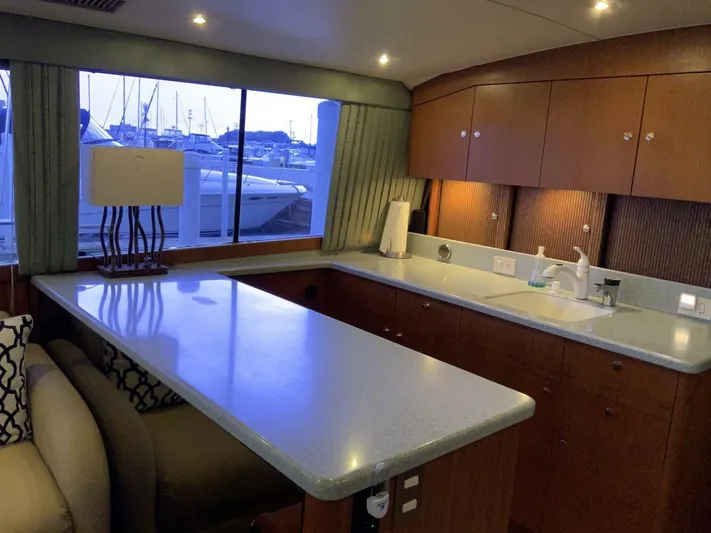 Bona Vida Yacht Photos Pics Interior of 1997 Ocean Yachts 48 Convertible with modern kitchen and marina view.